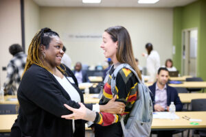 Tanya Dotson (left) and Amy DeFranco, DPT, a Washington University physical therapist who provided Dotson with care early in her recovery from long COVID, embrace during a meeting on the Medical Campus in November that included community partners, patients, physicians and other care providers.